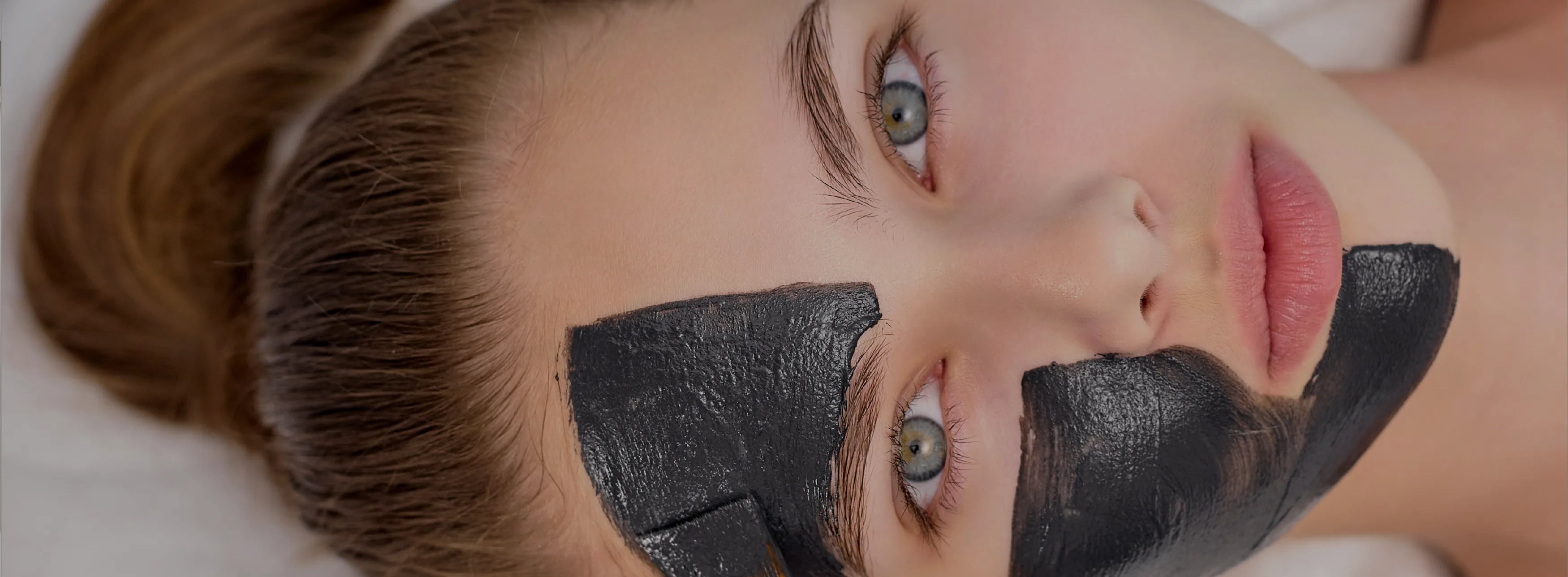 Woman with a black face mask on her nose, close-up shot.